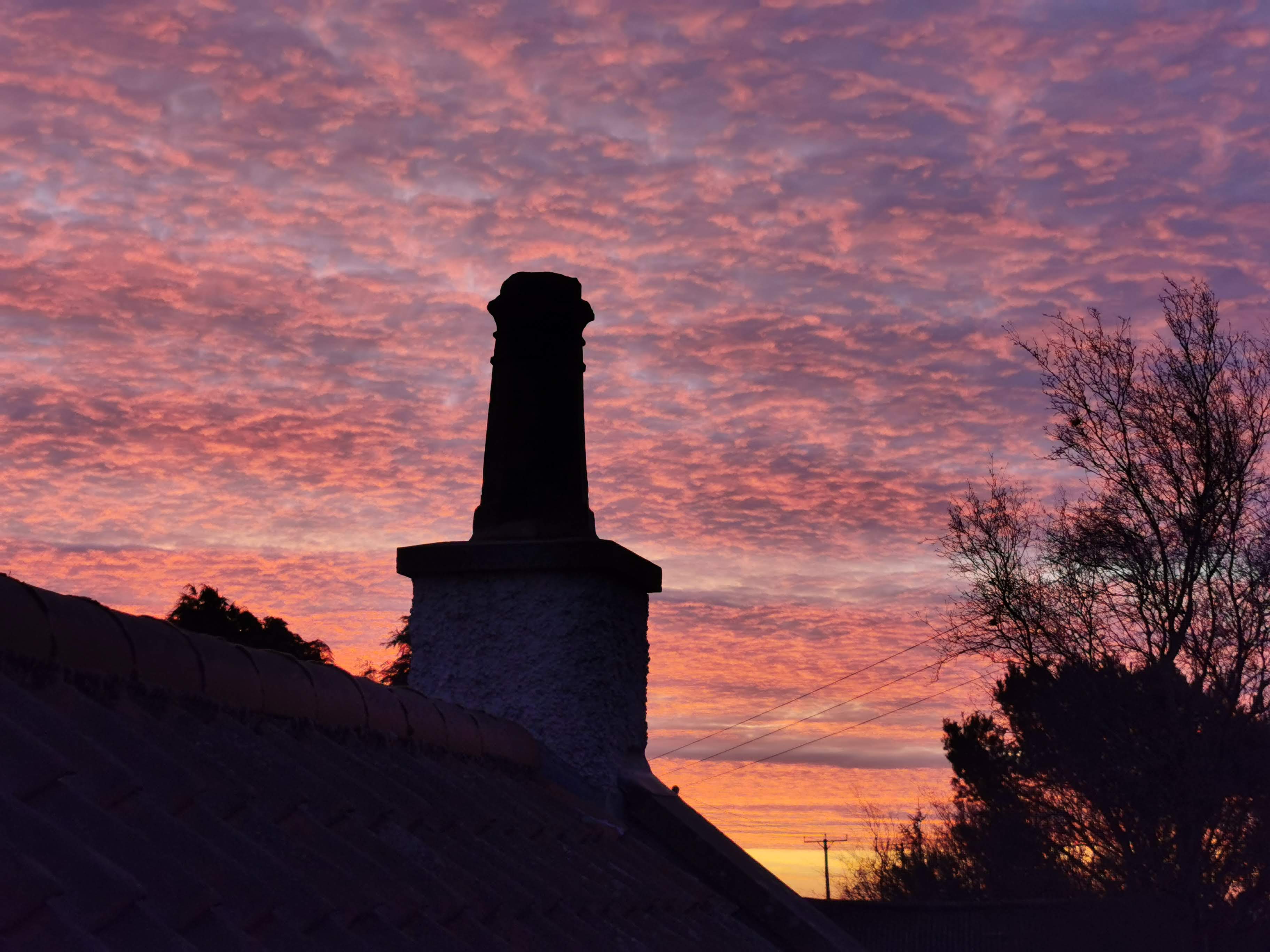 Pink sunset sky with chimney